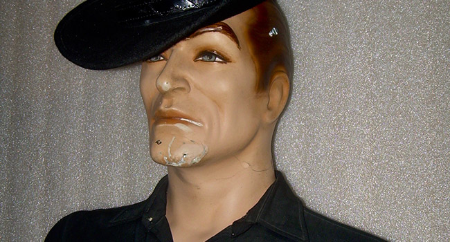 Close up of a male mannequin's chin during conservation treatment. A fill has been applied where materials were lost.